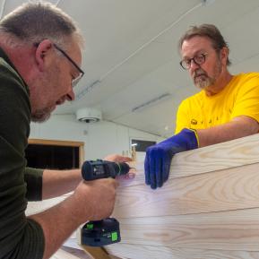 Pekka Lasilla and Jyrki Järvinen working on the canoe