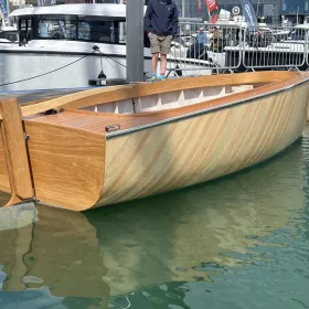 The Bluetree 5 electric motorboat in the water side view